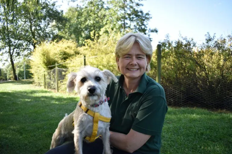 Woodgreen staff member outdoors with a dog
