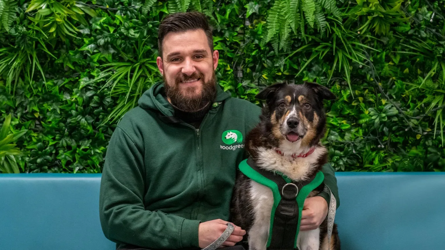 Chris from The Dog House on the sofa with black and white dog