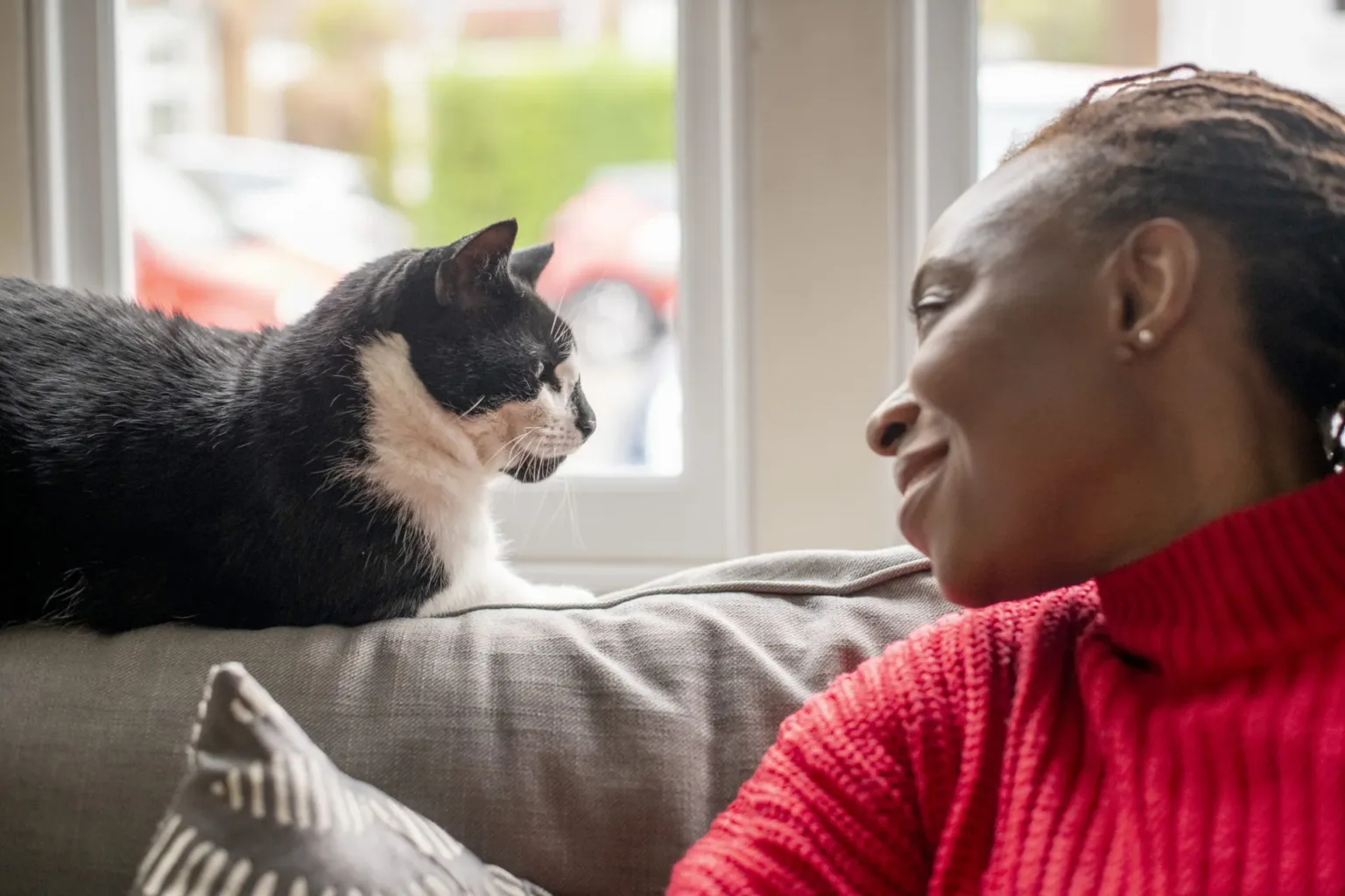 Woman and cat looking at each other