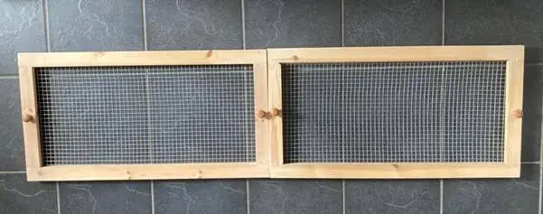 Two rectangular wooden frames with mesh wire centres, ideal as a gerbil homemade lid for tank, are joined side by side.